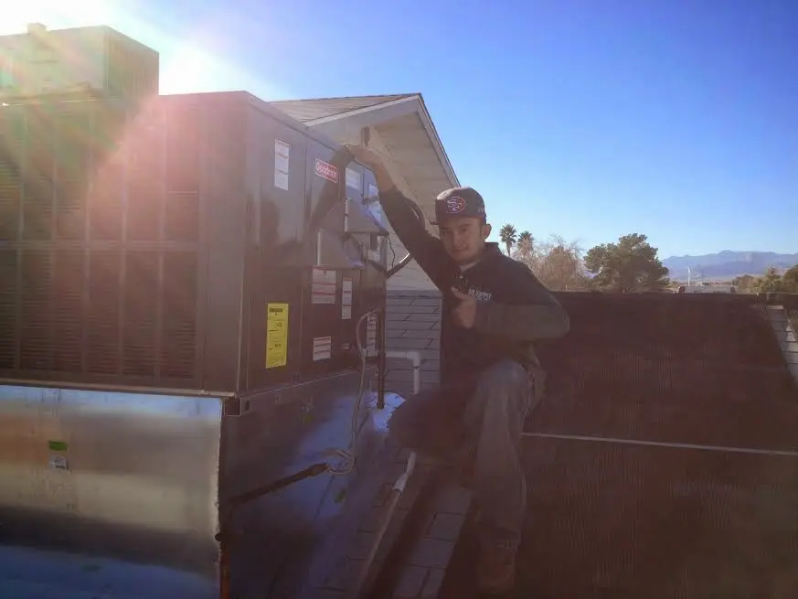 HVAC technician performing HVAC Inspection on a rooftop unit in Cottonwood Heights
